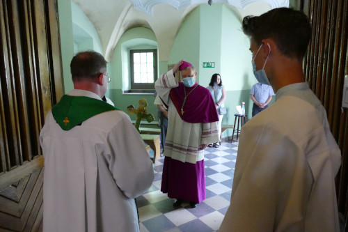 biskup Turzyński witający się z księdzem Proboszczem przy wejściu do kościoła, obok stojący ministrant